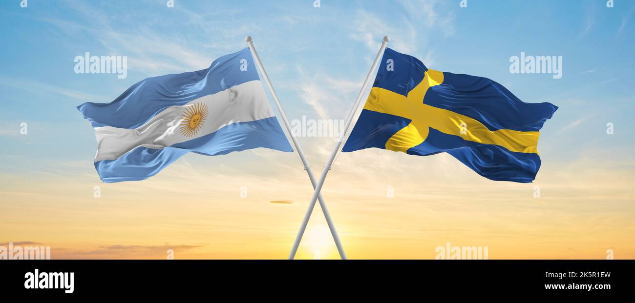 crossed national flags of Argentine and SWEDEN flag waving in wind at ...
