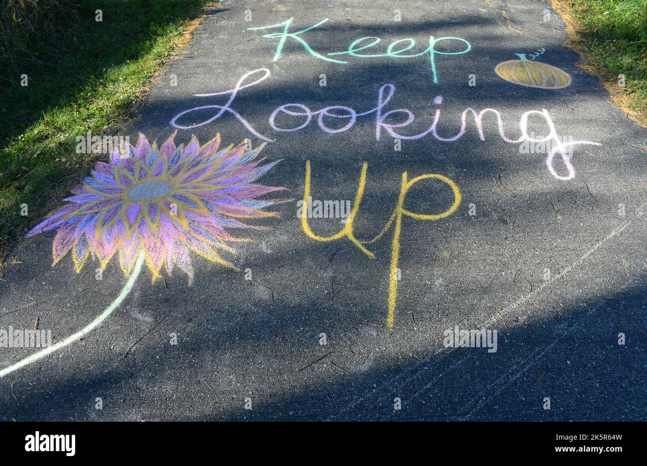 An uplifting chalk art message in our driveway in southwestern WI 'Keep Looking Up' Stock Photo