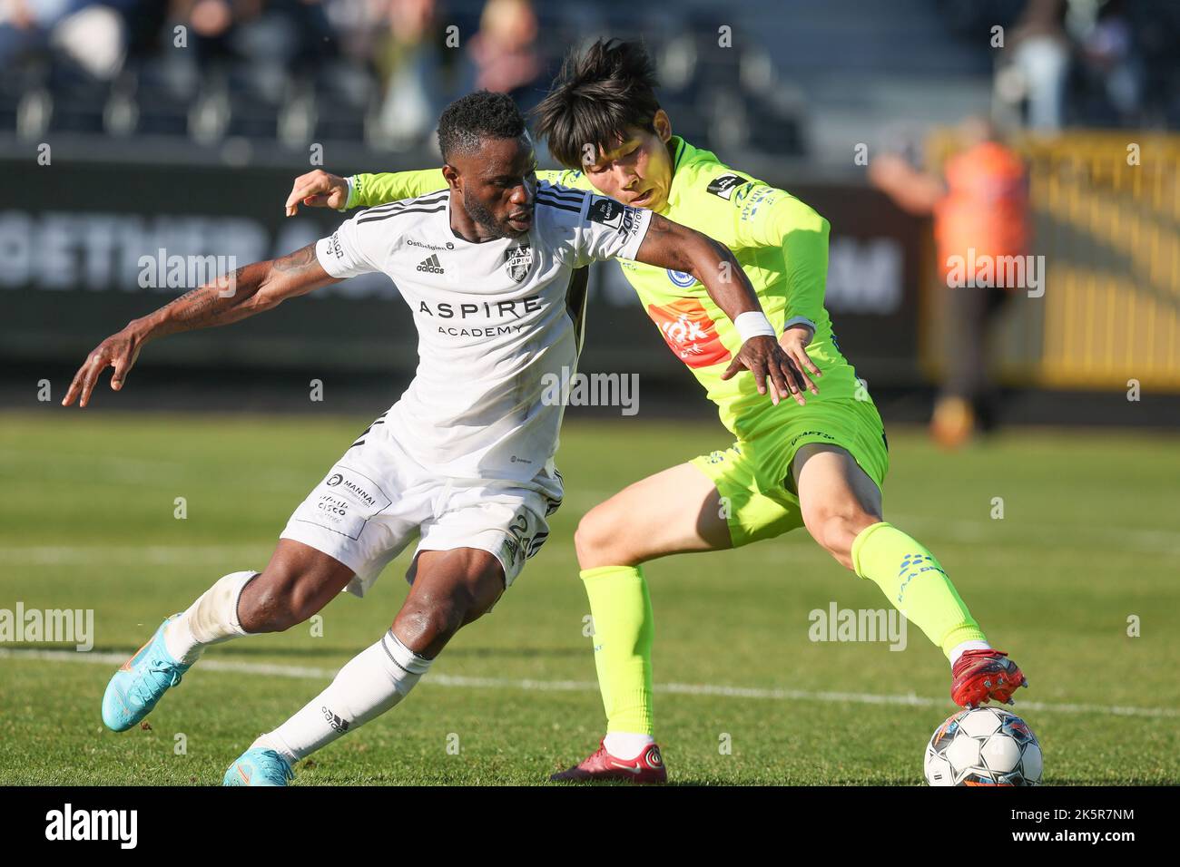Eupen's Mubarak Wakaso and Gent's Hyunseok Hong fight for the ball during a soccer match between KAS Eupen and KAA Gent, Sunday 09 October 2022 in Eupen, on day 11 of the 2022-2023 'Jupiler Pro League' first division of the Belgian championship. BELGA PHOTO BRUNO FAHY Stock Photo
