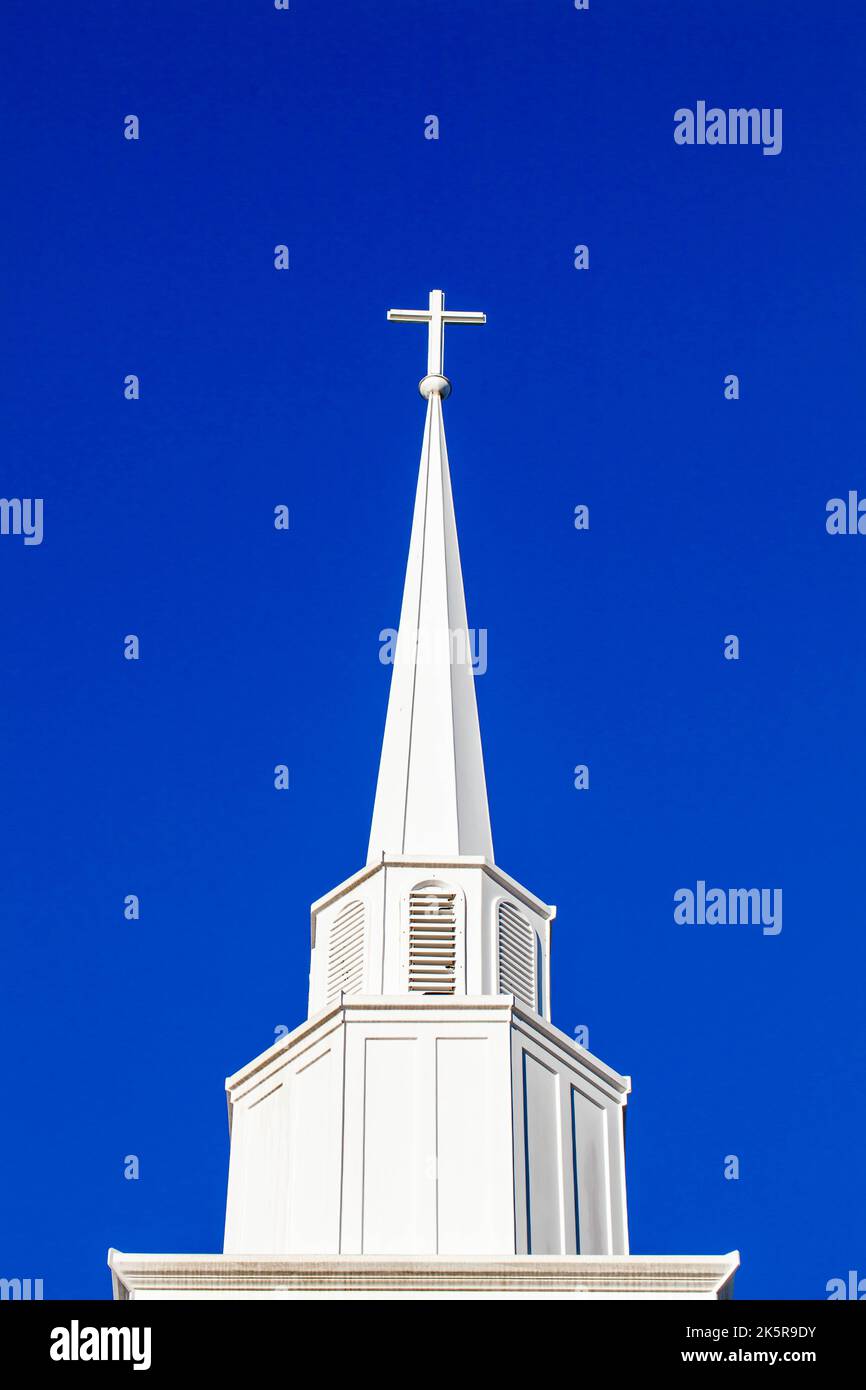 White cross on top of a steeple with copy space, vertical Stock Photo