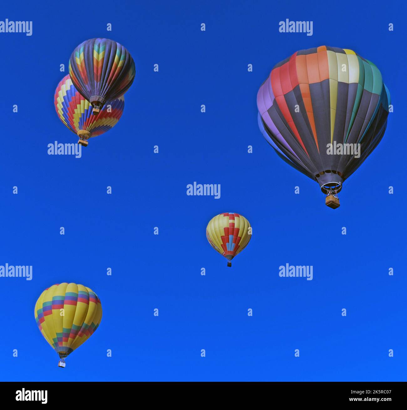 Five colorful hot air balloons in the sky over Pagosa Springs, Colorado