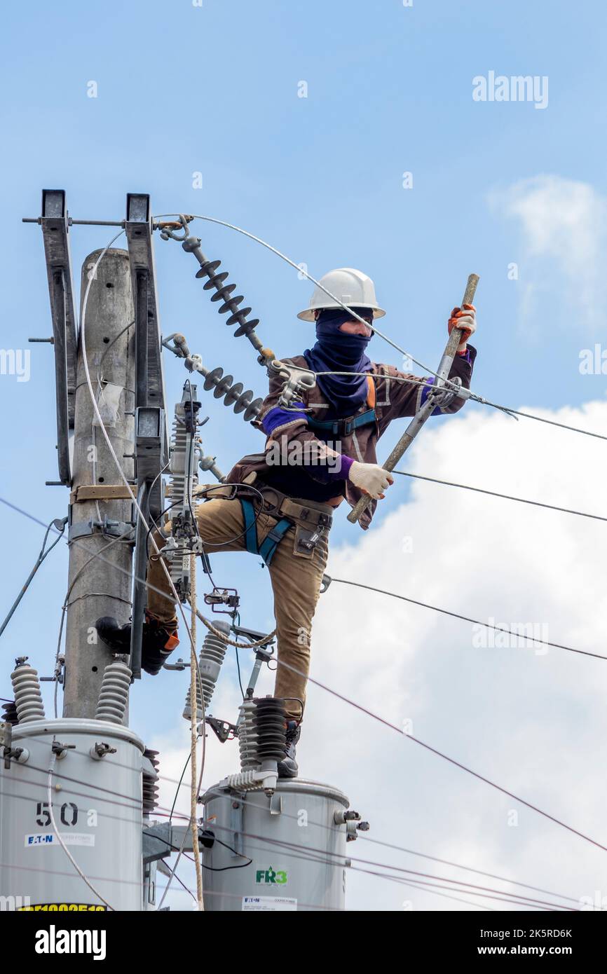 A lineman from a power company working on an electric pole in Cebu City