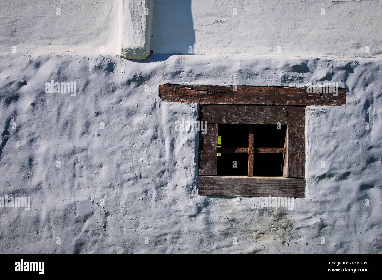 Old wooden window on the white wall of the house Stock Photo - Alamy