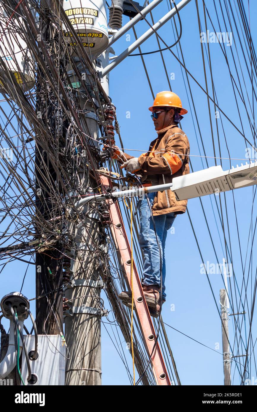 A lineman from a power company working on an electric pole in Cebu City