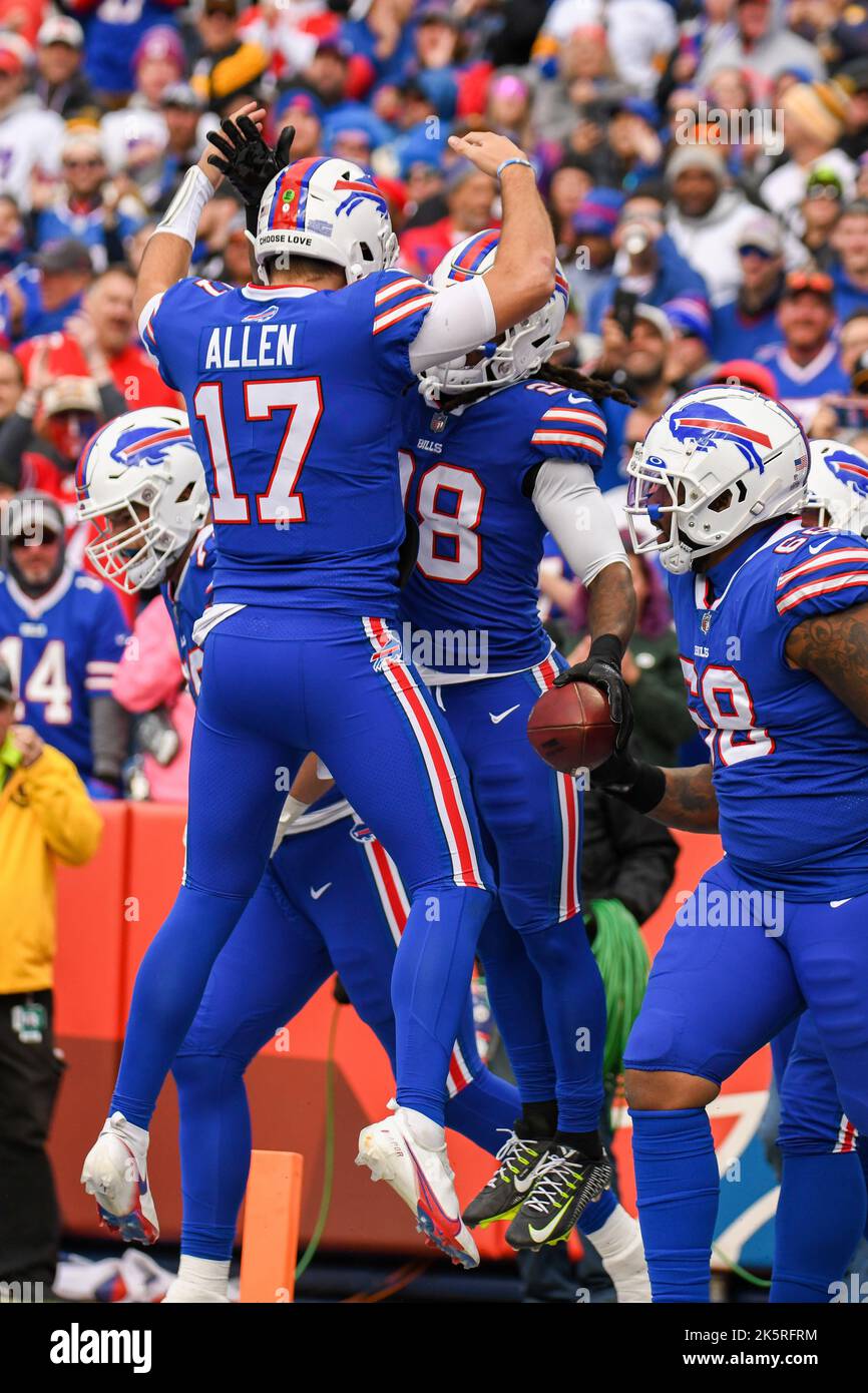 Denver Broncos head coach Josh McDaniels (R) congratulates running back  LenDale White (26) after his two-yard touchdown run against the Pittsburgh  Steelers during the first quarter at Invesco Field at Mile High