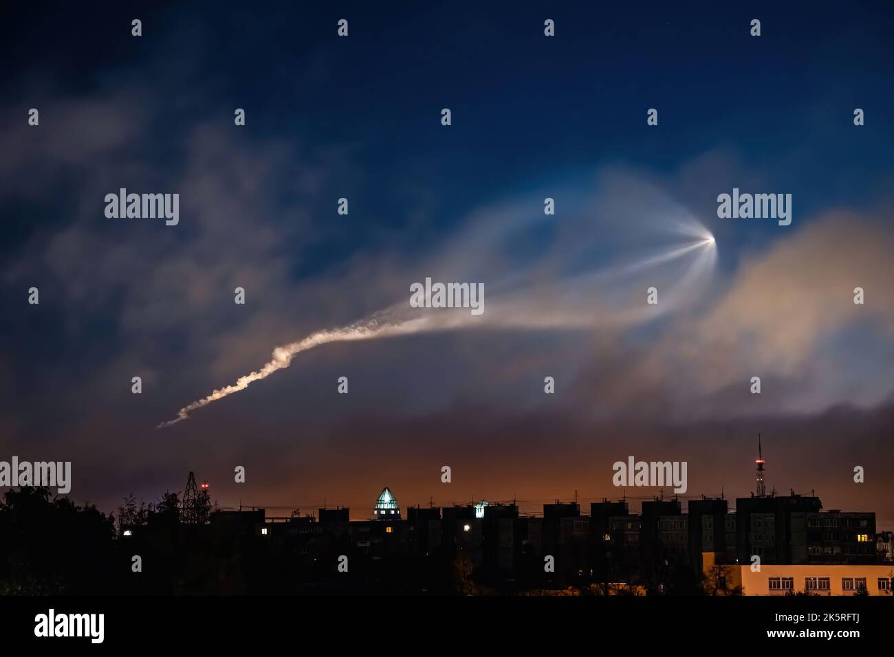 Soyuz space rocket launch. Space jellyfish in sky. Plume of rocket gases in sun at dawn. Jet trail from space rocket. Astronomical phenomenon over cit Stock Photo