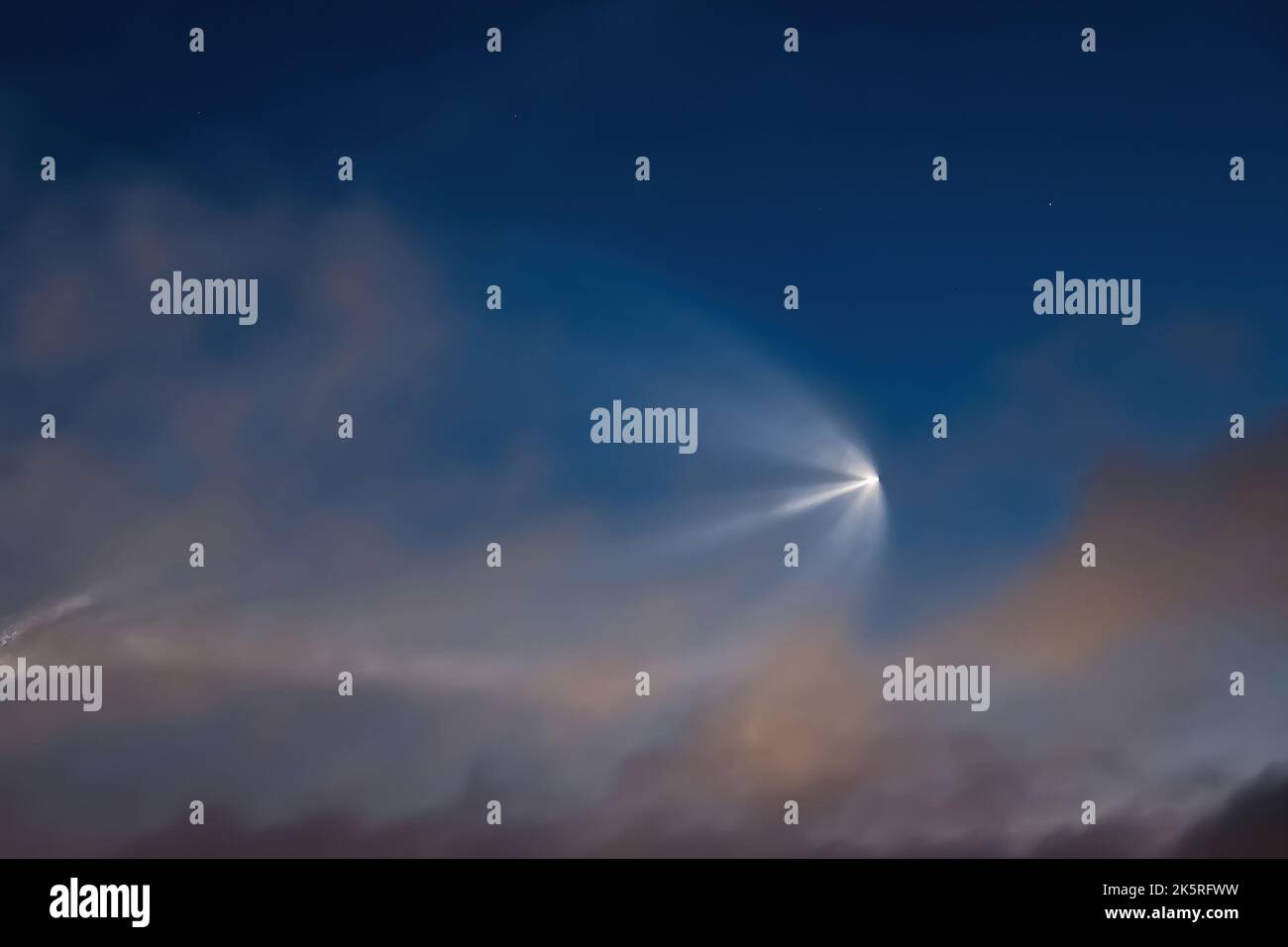 Soyuz space rocket launch. Space jellyfish in sky. Plume of rocket gases in sun at dawn. Jet trail from space rocket. Astronomical phenomenon over cit Stock Photo