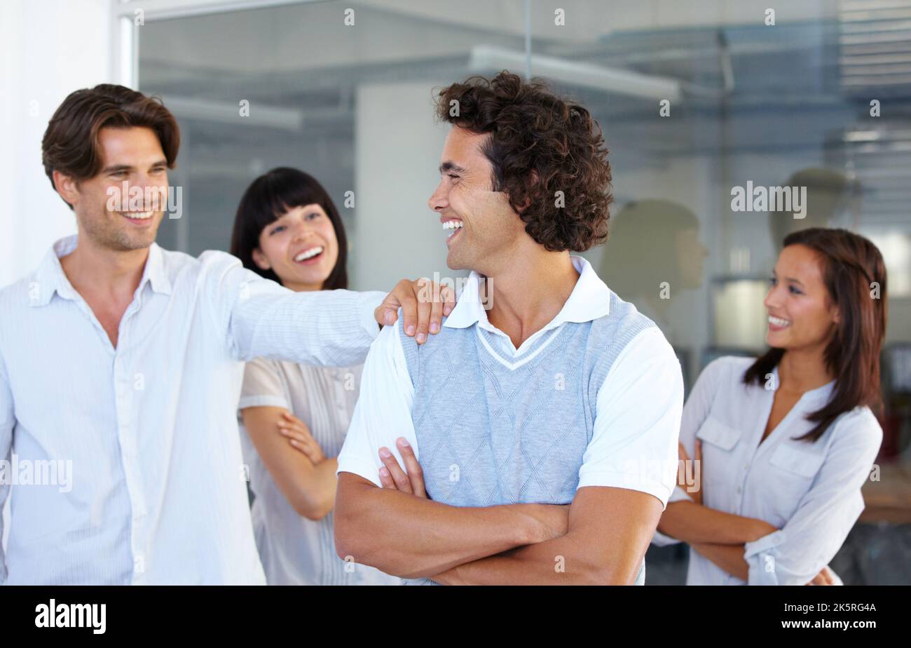 Well done on a job well done. Associates congratulate a colleague on a job well done. Stock Photo