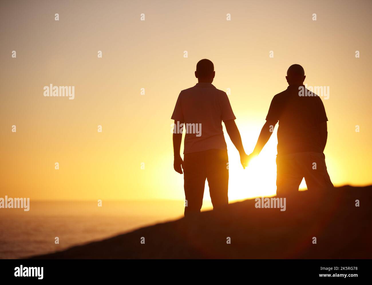Gay couple watching sunset hi-res stock photography and images - Alamy