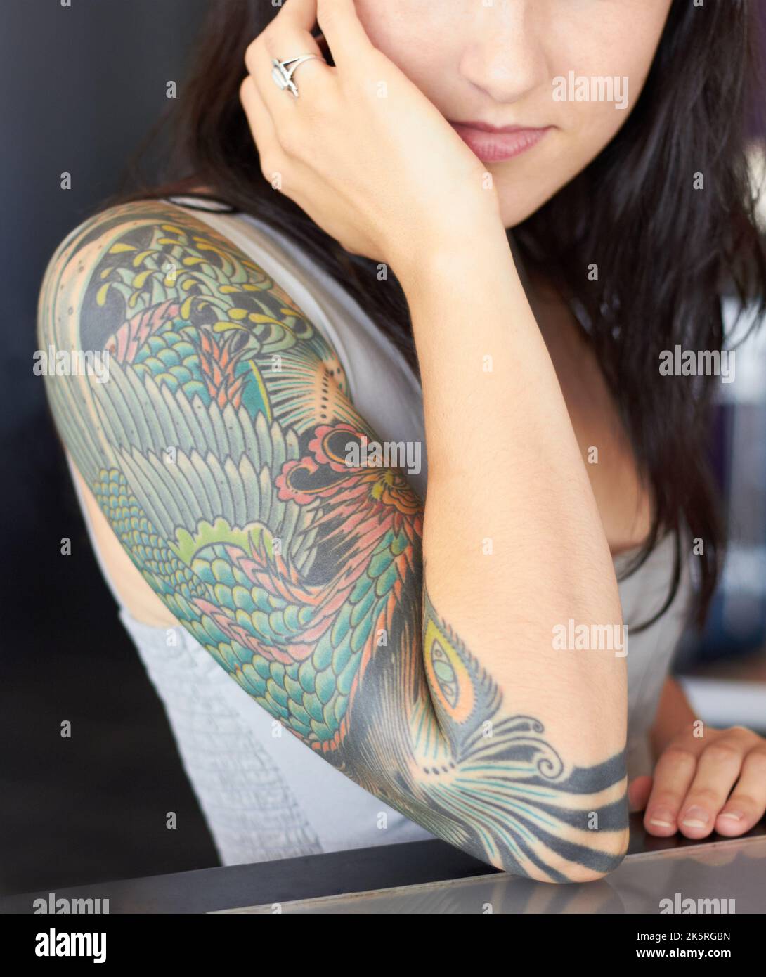Proud to display living artwork. a young tattoo artist showing off her half-sleeve tattoo. Stock Photo