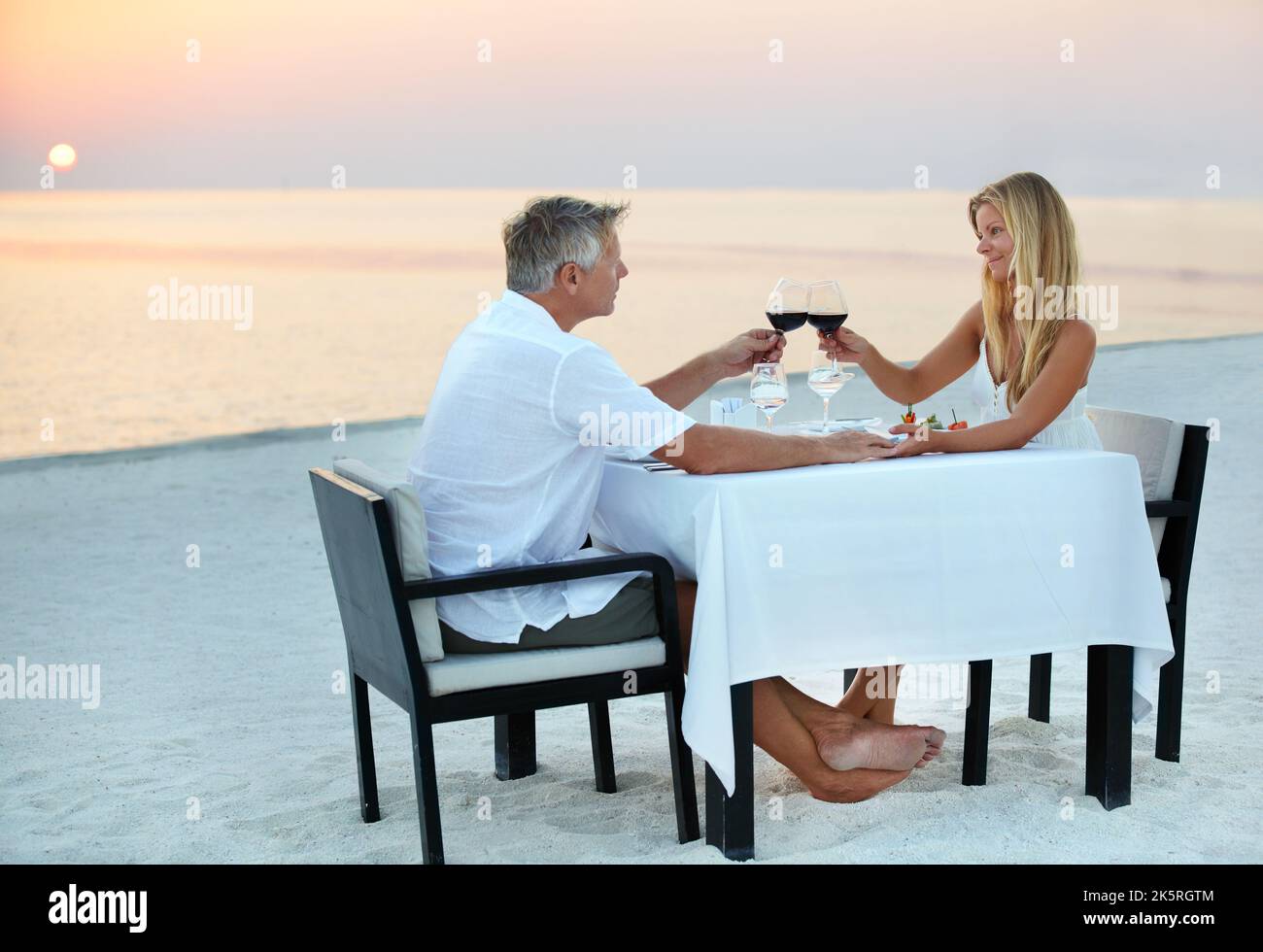 The Perfect Anniversary A Mature Couple Enjoying A Romantic Dinner On