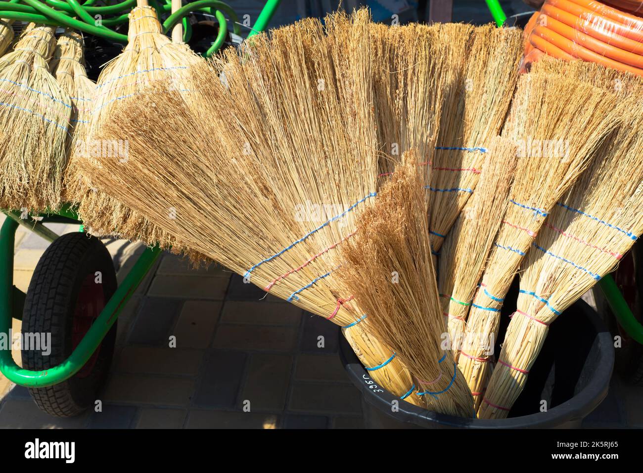 A bunch of brooms. Broom trade. Straw backgrounds. Natural handmade accessories for basting