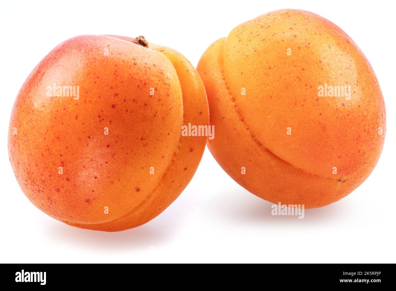 Two ripe apricots isolated on white background. Stock Photo
