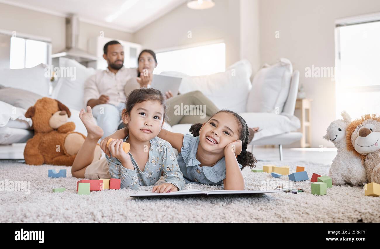 Little two girls drawing with colouring pencils lying on living room ...