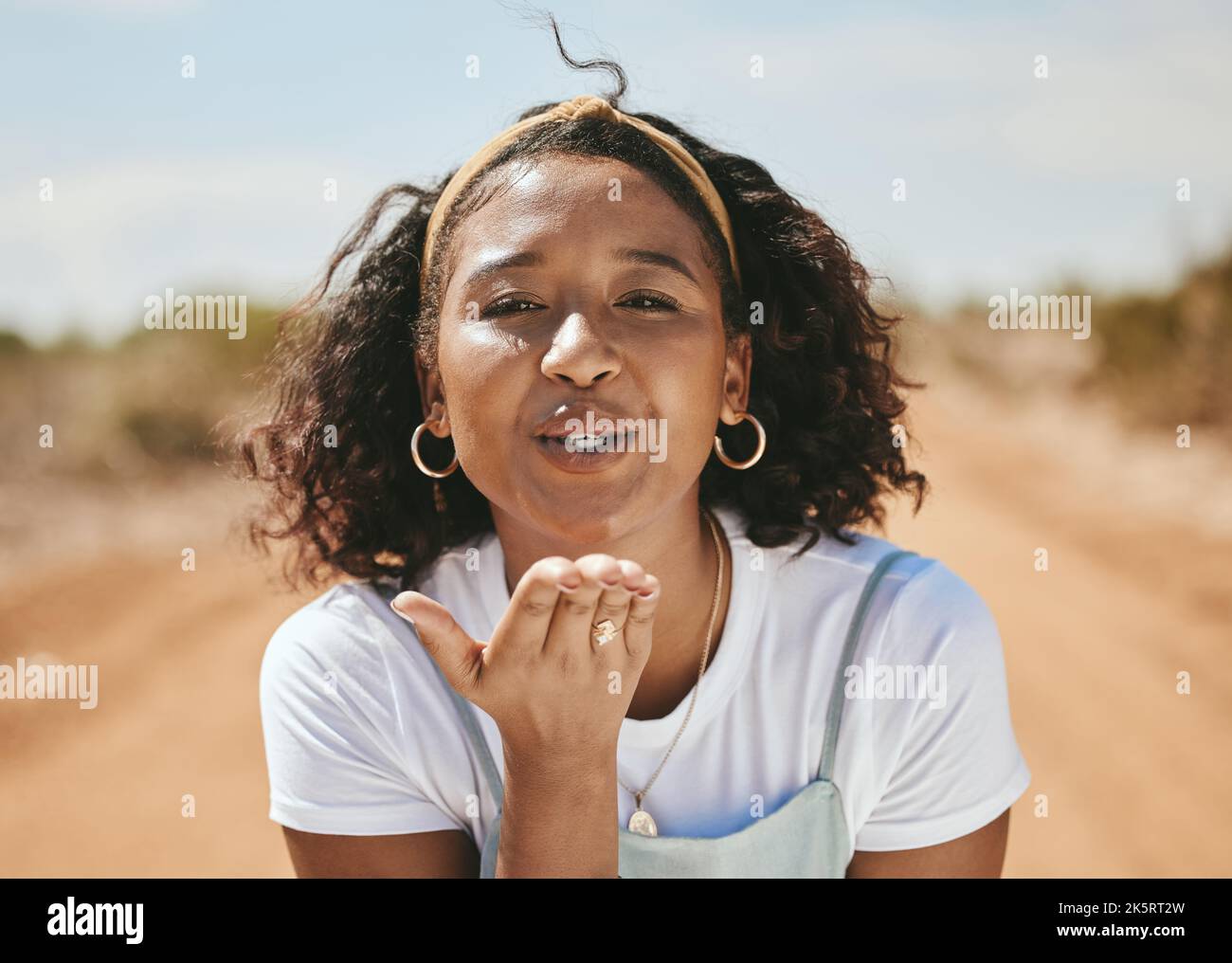 Happy woman, blowing kiss and portrait for love emoji, relax and