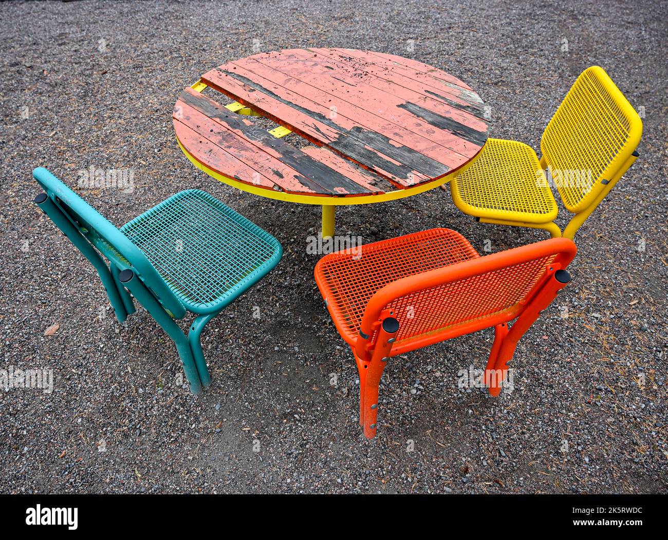 colorful chairs in metal standing outside in park Stock Photo