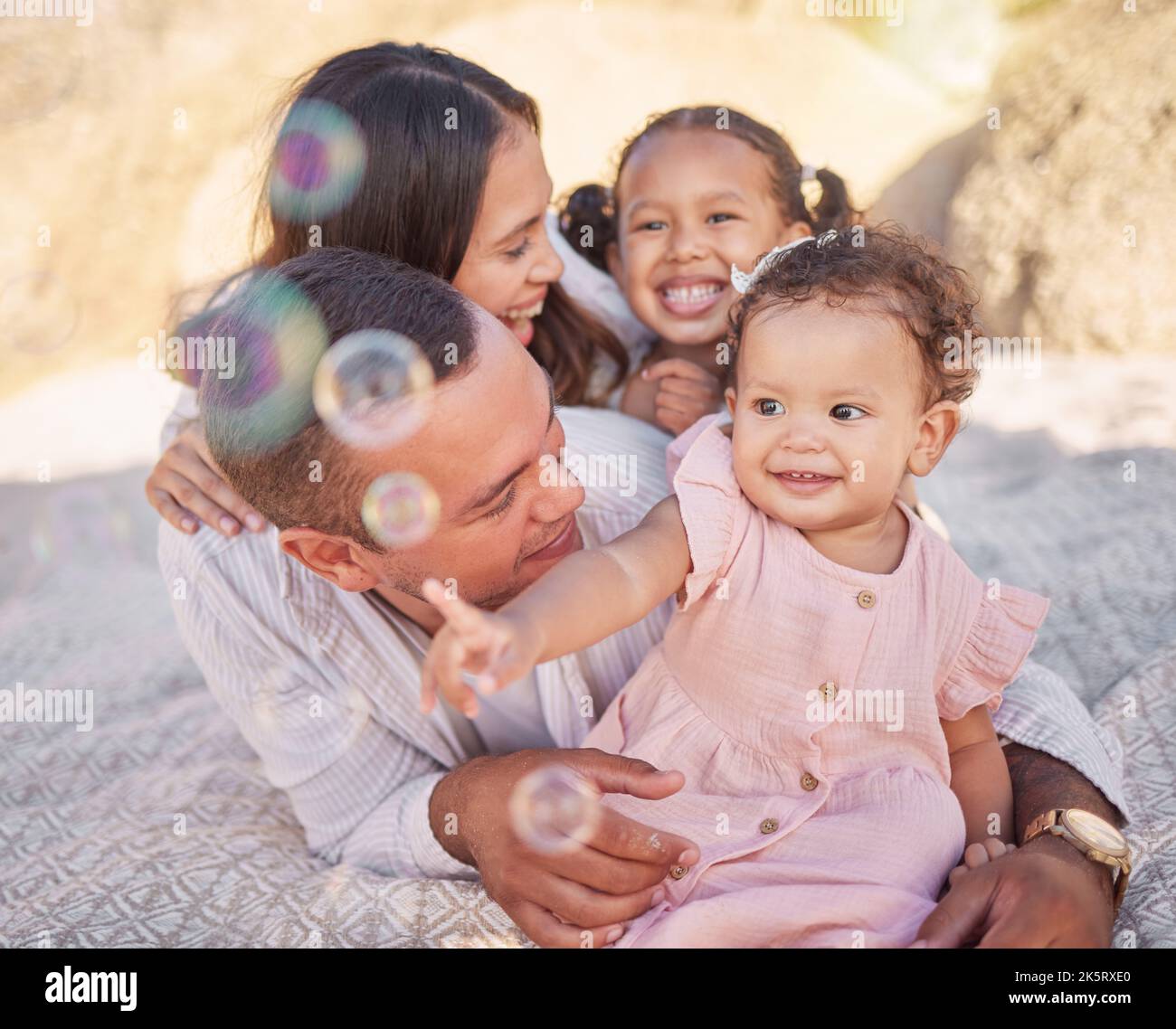A happy mixed race family of four enjoying fresh air at the beach