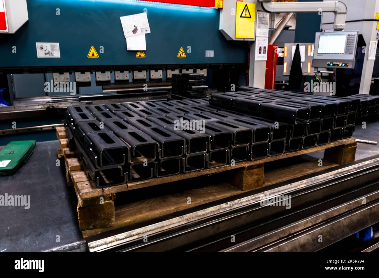 Special steel profile prepared in CNC machine stands in a heap. Selective focus profiles. Stock Photo