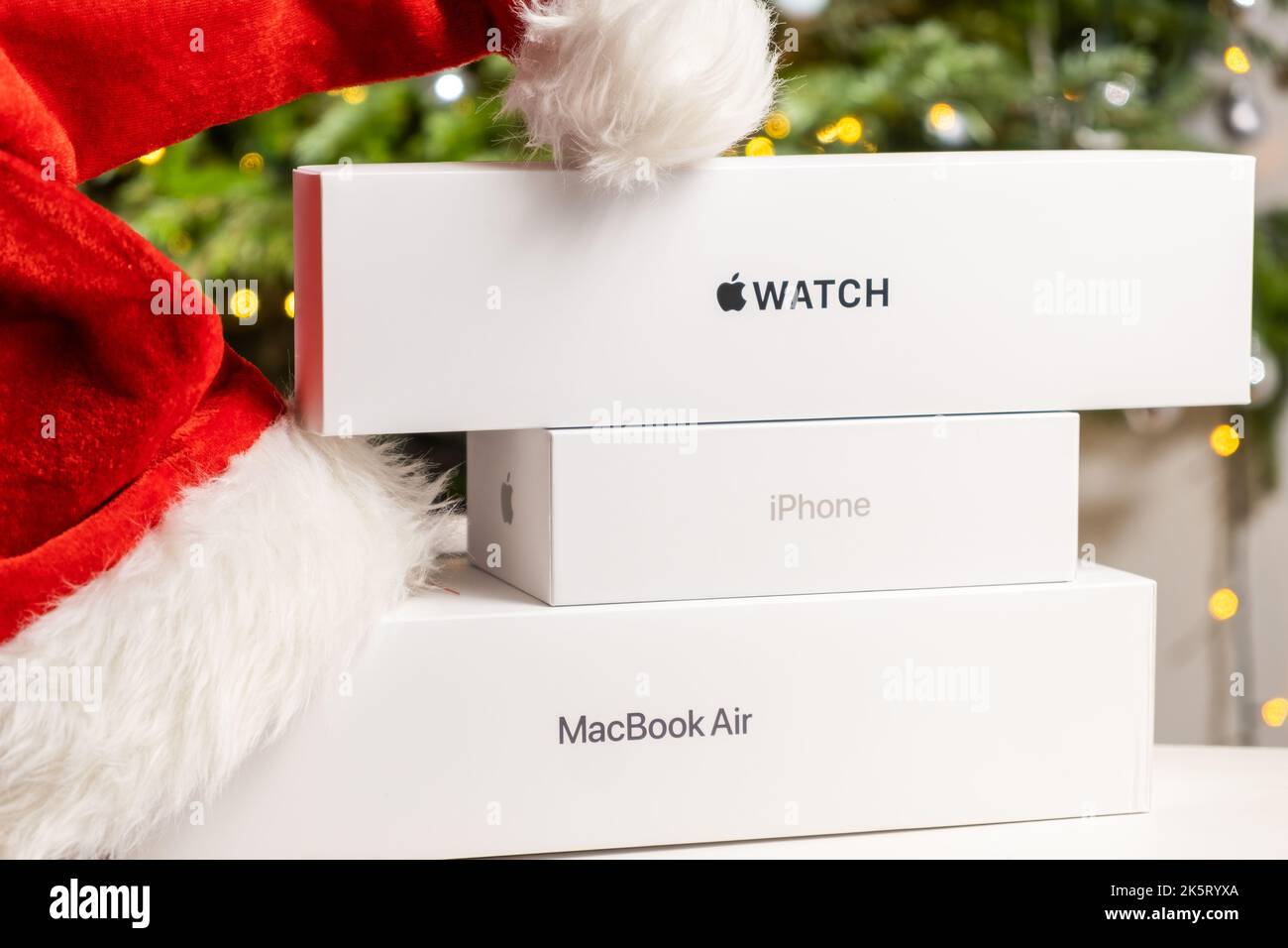 Iphone, Apple watch, Macbook Air boxes with Santa Claus hat and