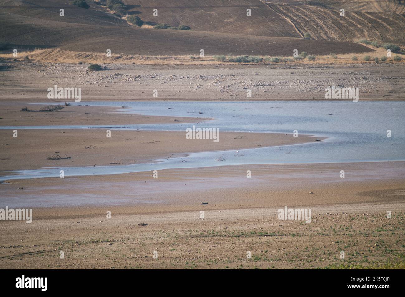 Concept: drought. Artificial swamp to reserve water for human consumption drying up due to climate change. Stock Photo
