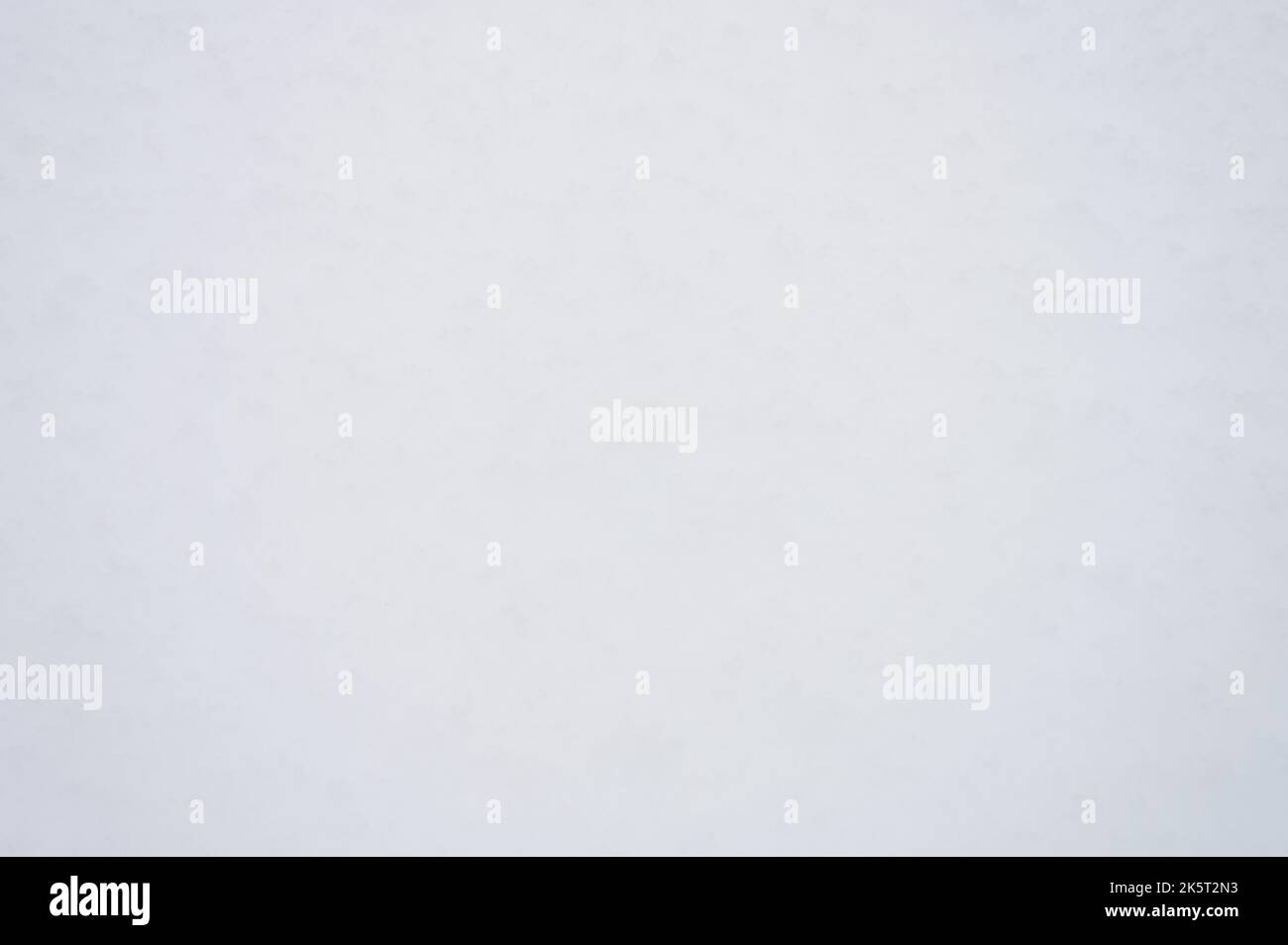 winter background texture fresh snow covering ground. natural abstract pattern flat rough coating snow surface. white icy frozen snowflakes on light c Stock Photo