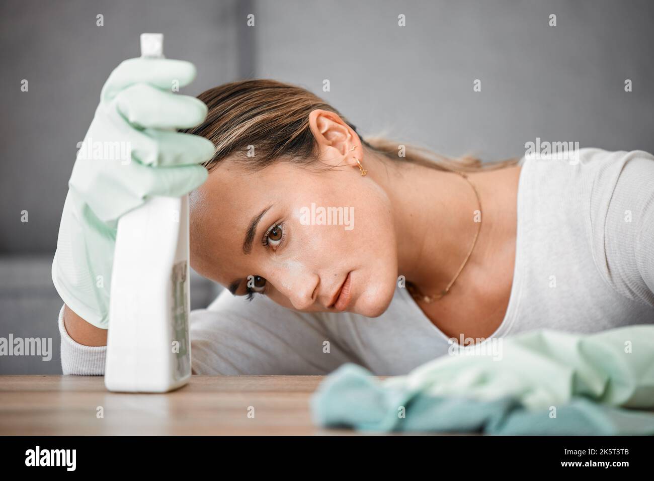 Spring cleaning house, tired and sad woman in home living room with
