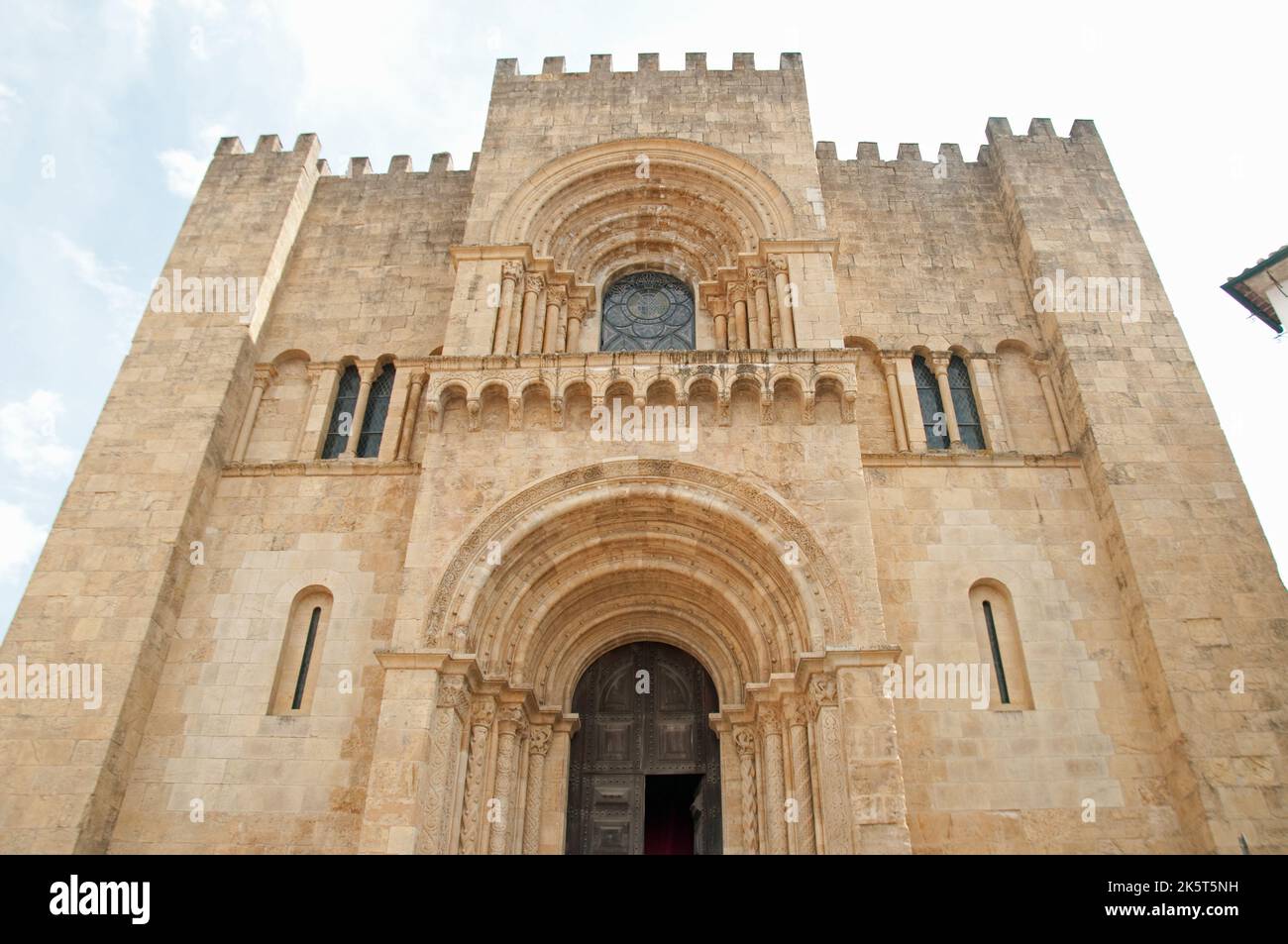 West Facade of the Old Cathedral (Se Velha de Coimbra); Coimbra, Portugal - Romanesque Church. Construction of the Sé Velha began some time after the Stock Photo