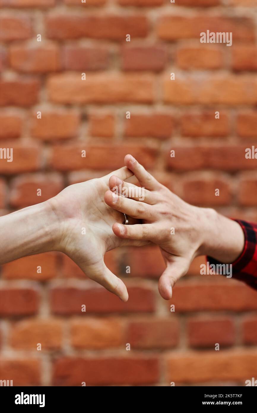 Vertical close up of two male hands greeting each other with special