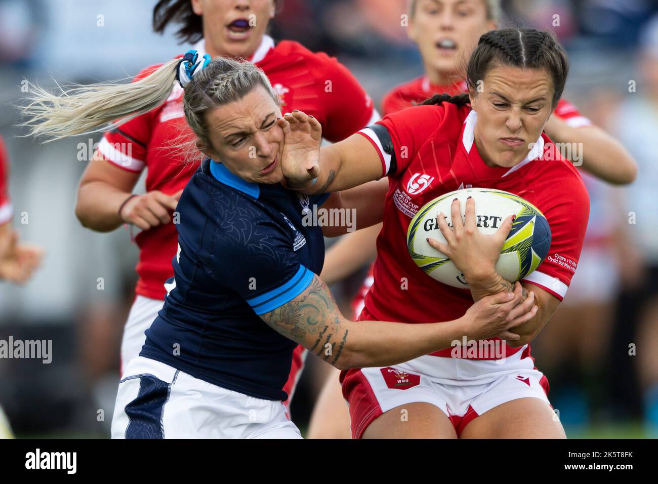 Wales' Ffion Lewis puts a fend on Scotland's Chloe Rollie during the