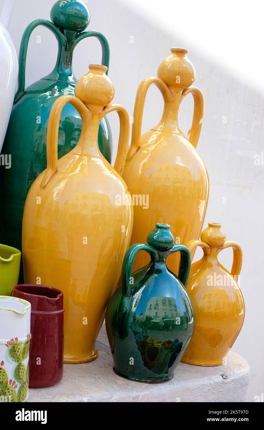 yellow and green vases outside shop in locorotondo, puglia, southern
