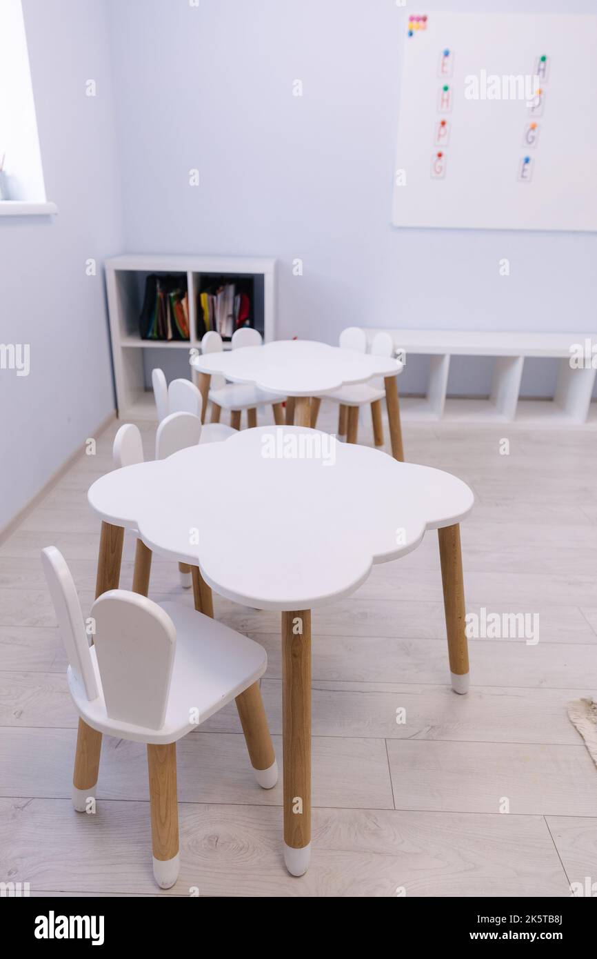 Little white table for kids in private kindergarten. Development and education of children Stock Photo