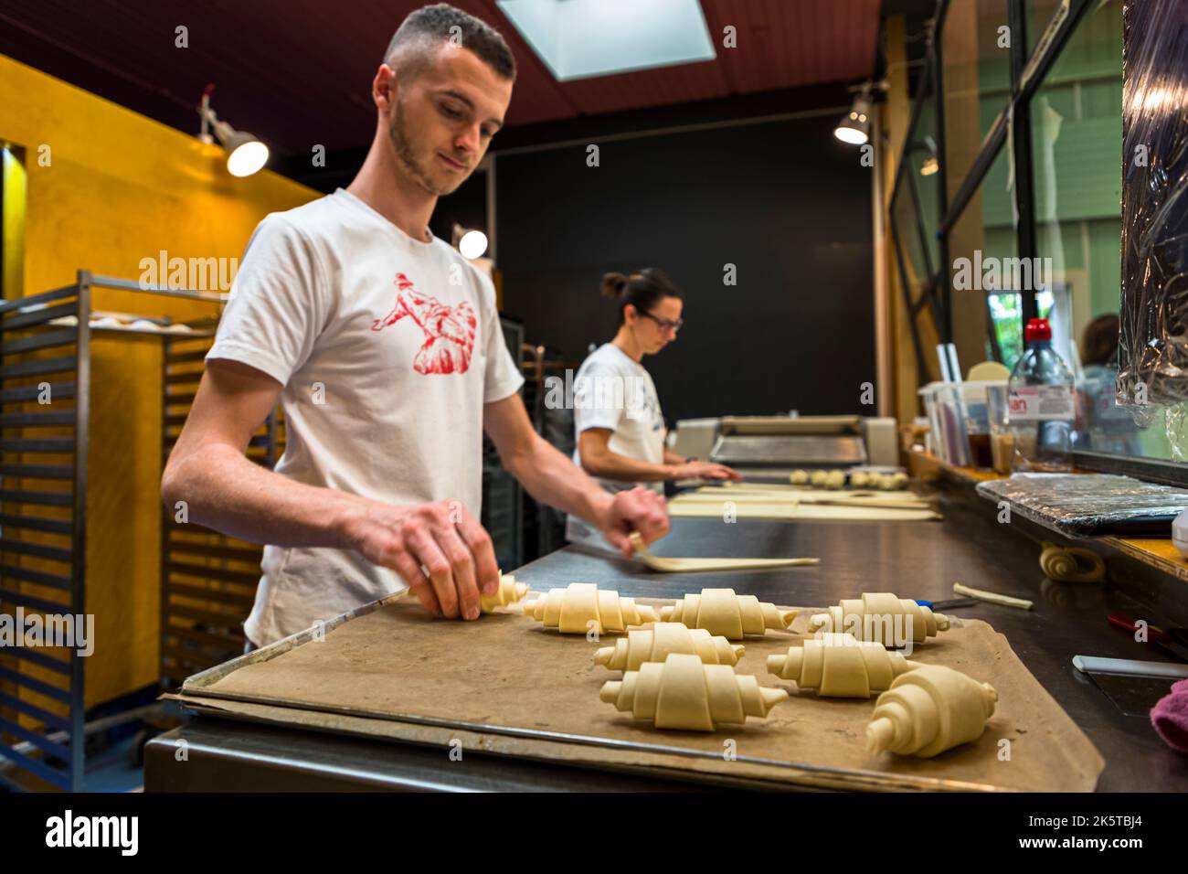At the KULT bakery, you can watch the bakers at work through the glass. Croissants are made here, which are called summits in Basel Stock Photo