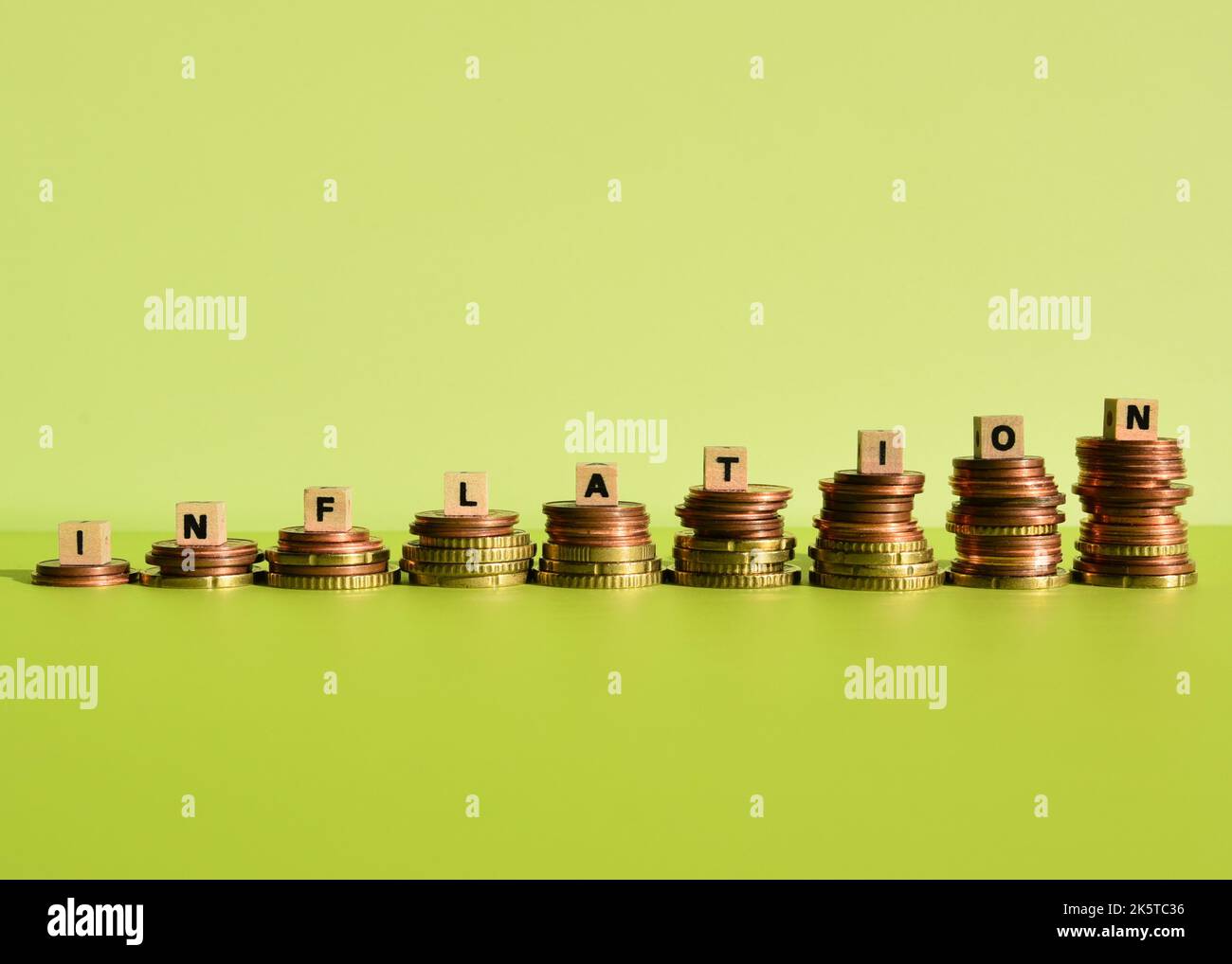the german word inflation with wodden cubes and euro coin stacks Stock Photo