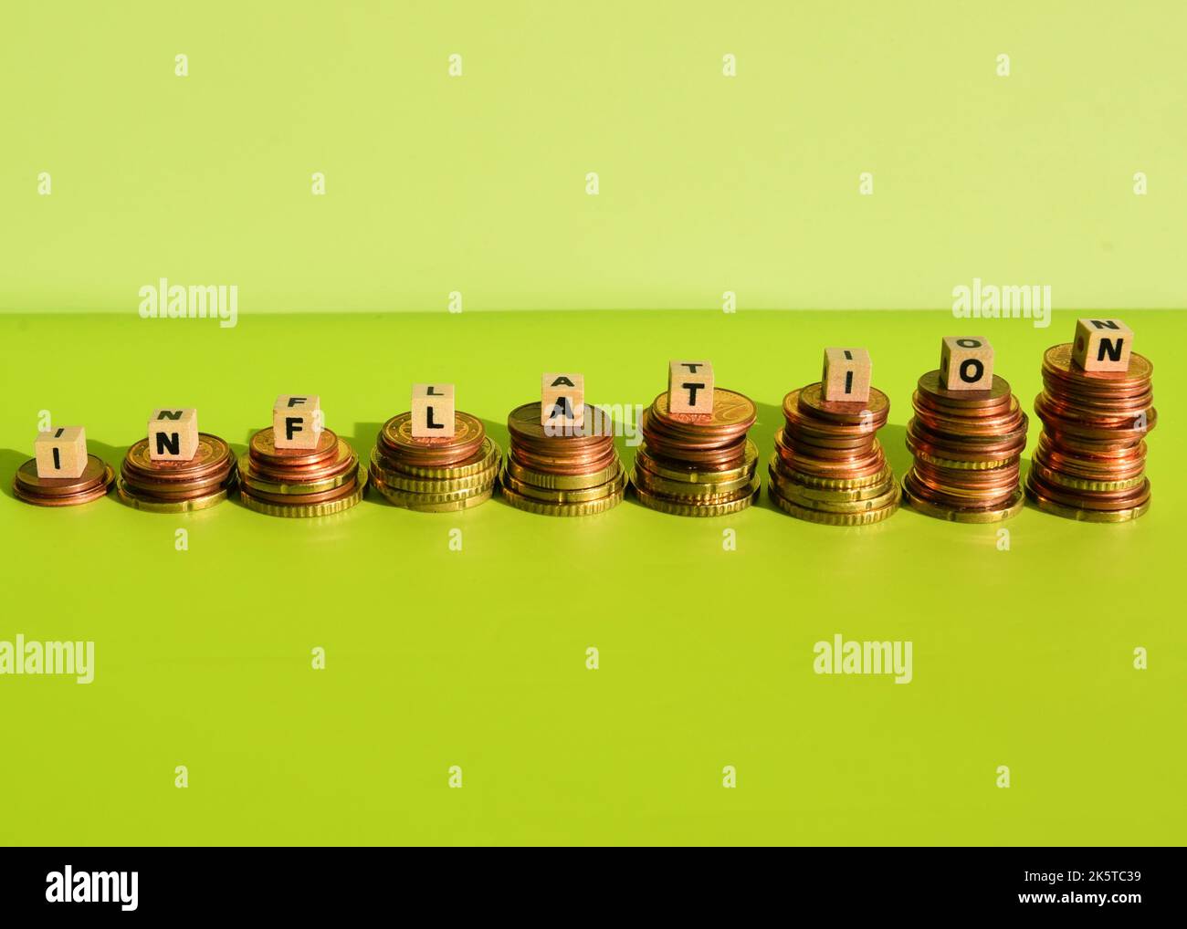 The German Word Inflation With Wodden Cubes And Euro Coin Stacks Stock