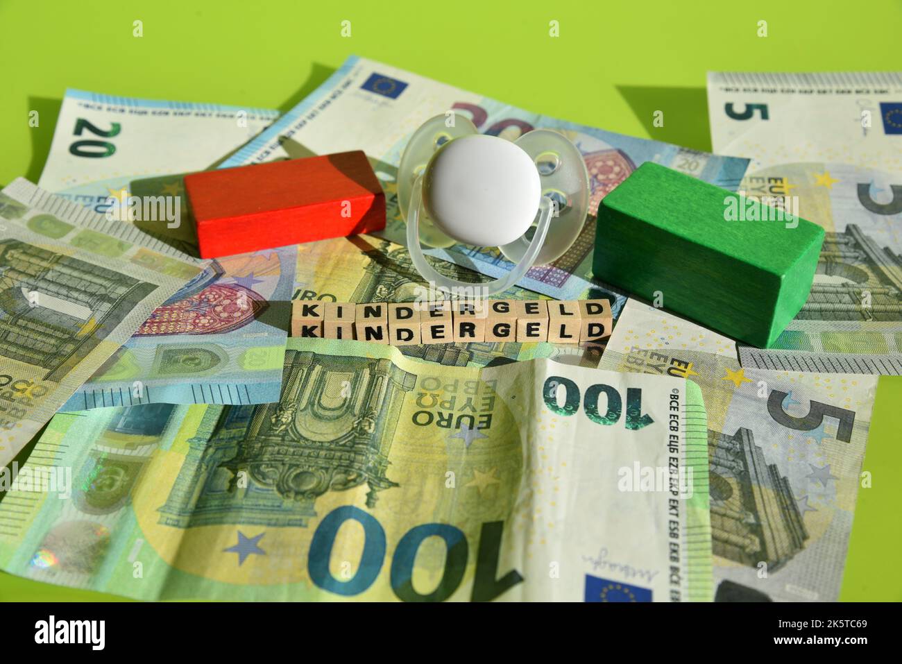the german word for child benefit with wodden cubes and euro bills Stock Photo