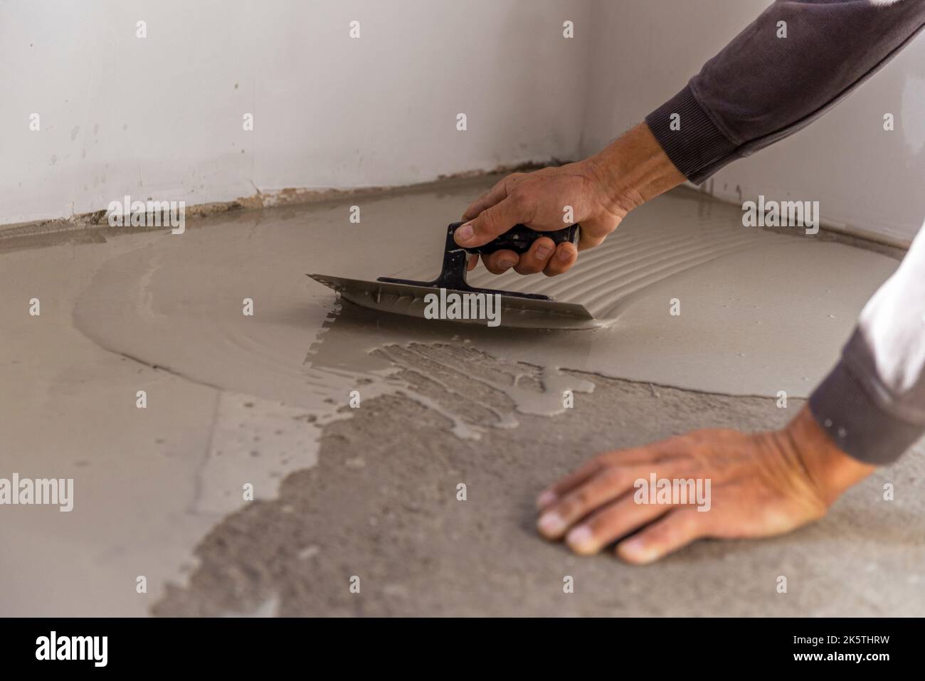 Construction workers are painting the floor using the method self