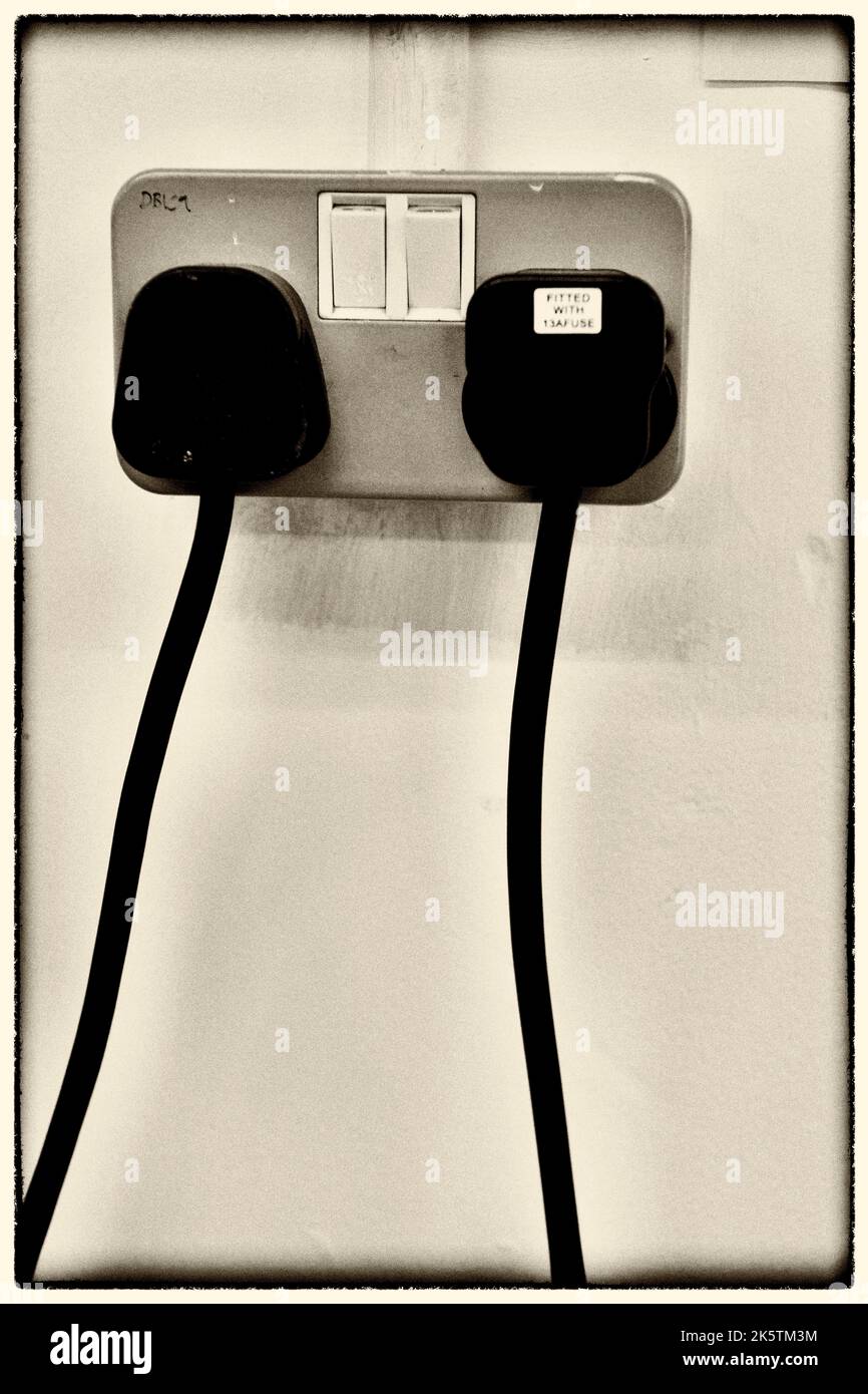 13 amp plugs in electrical sockets Stock Photo
