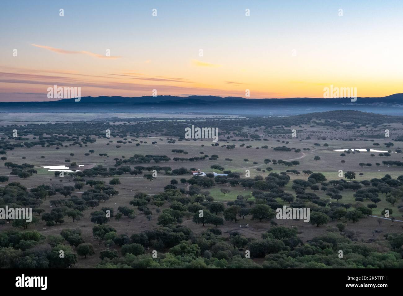 Silhouette at dawn of mountains bordering Spain overlooking the rural agricultural fields in Alentejo Portugal Stock Photo