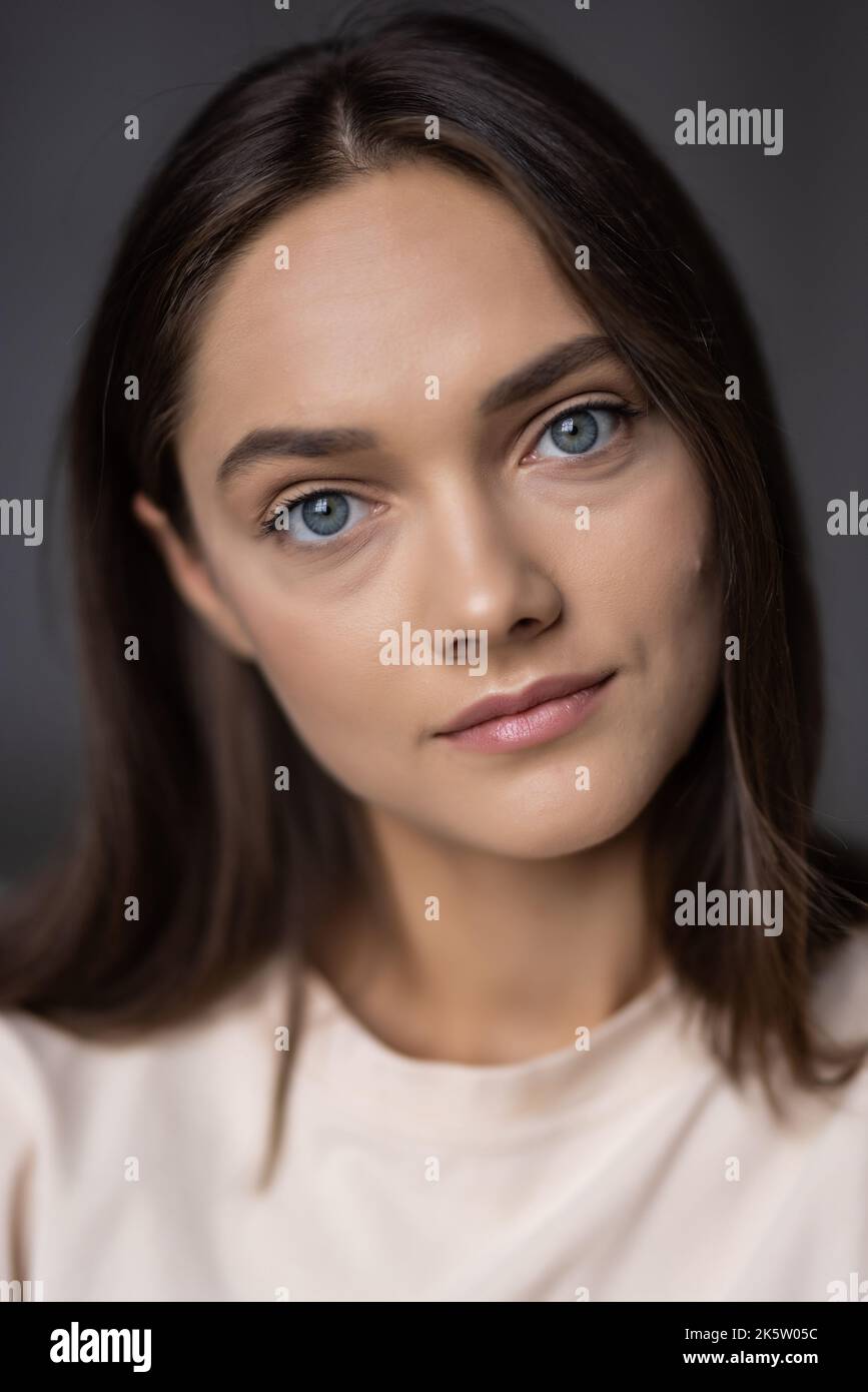 Portrait of a beautiful smiling young girl in casual clothes standing ...