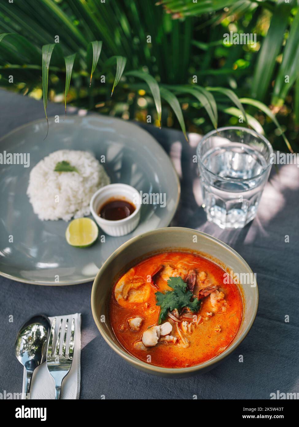 Asian soup 'Laksa' under palm tree at sunny day Stock Photo