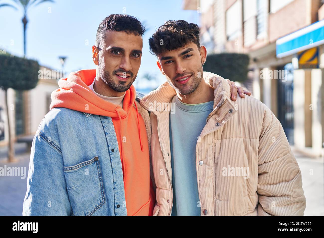 Two man couple hugging each other standing at street Stock Photo - Alamy