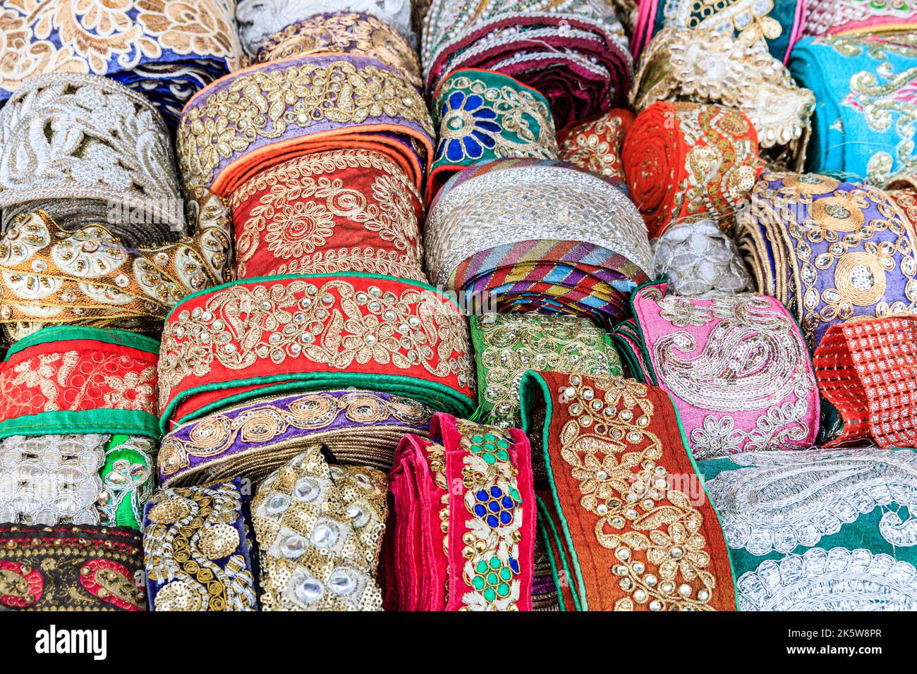 Colourful Indian and Asian fabric trims with patterned stitching, close up Stock Photo
