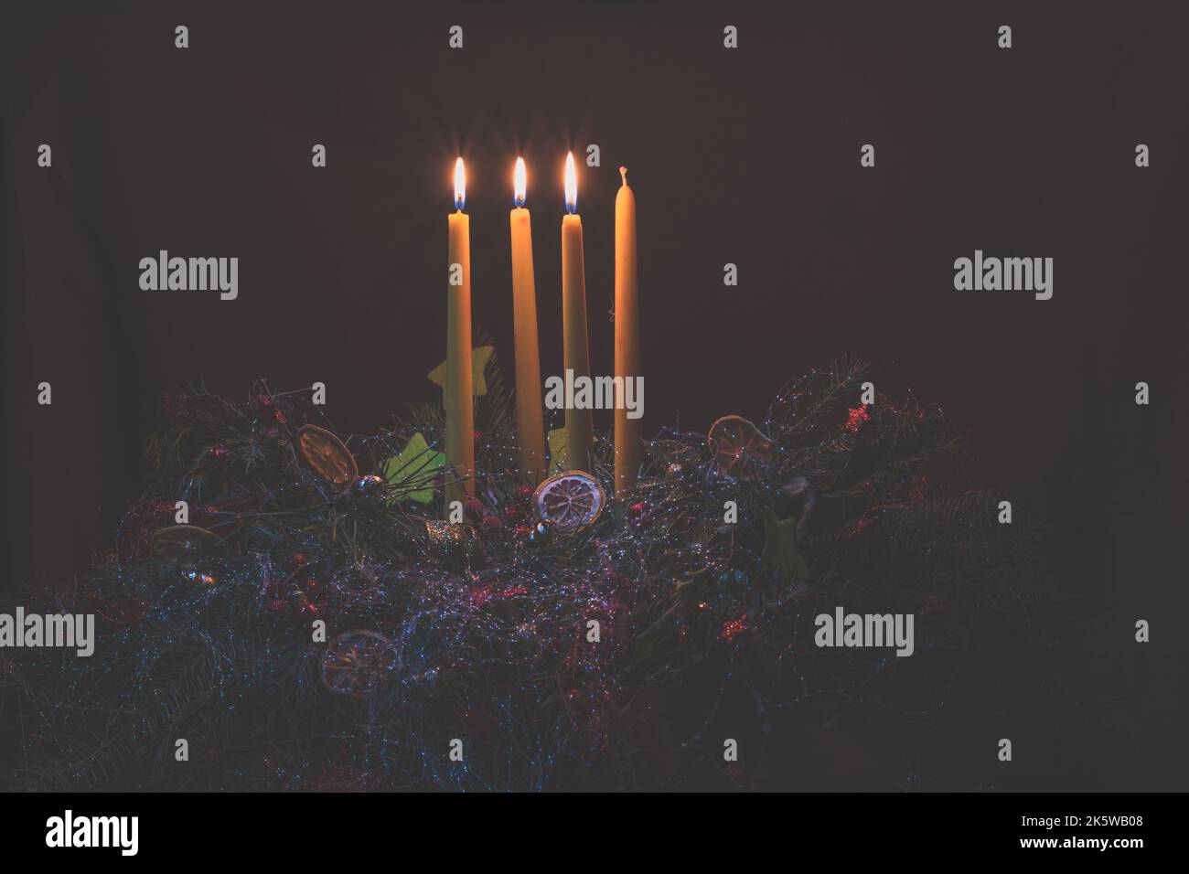 3 burning advent candles on black background Stock Photo Alamy