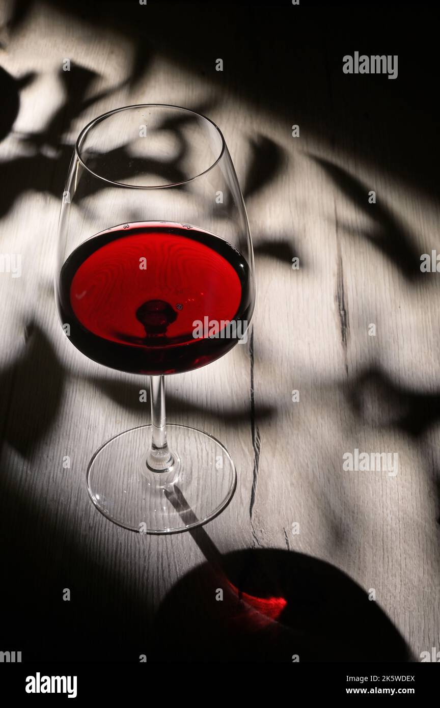 Abstract shadows, sunlight and Glass Of Dry Red Wine Stock Photo Alamy