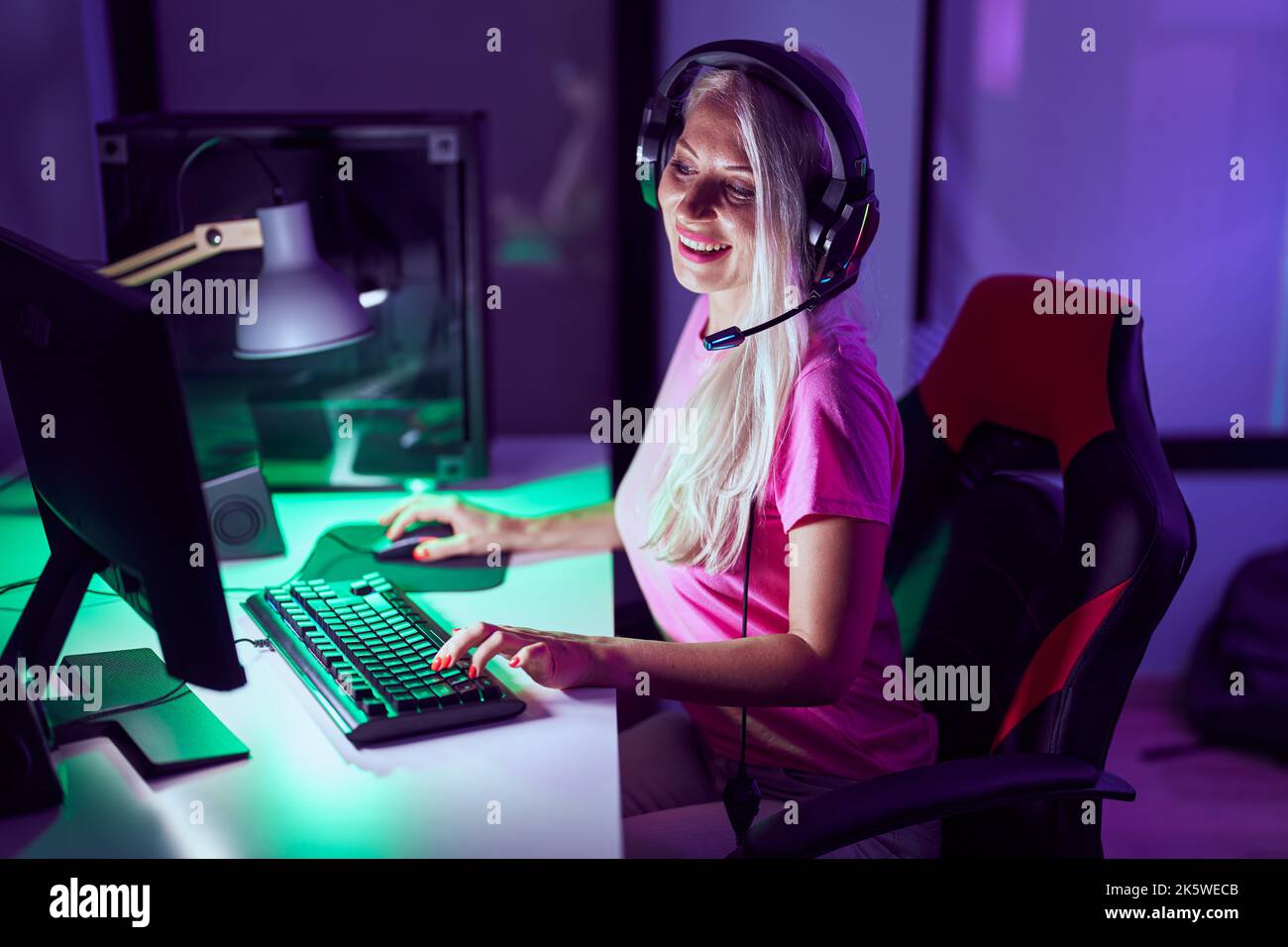 Blonde Computer Program Young blonde woman streamer smiling confident using computer at gaming ...
