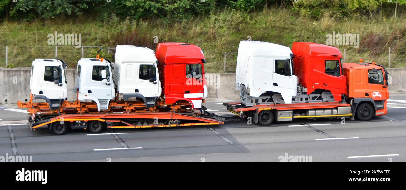 Six factory-new variants DAF lorry truck cab body specialised commercial vehicle transport & adjustable low loader trailer driving on UK motorway road Stock Photo