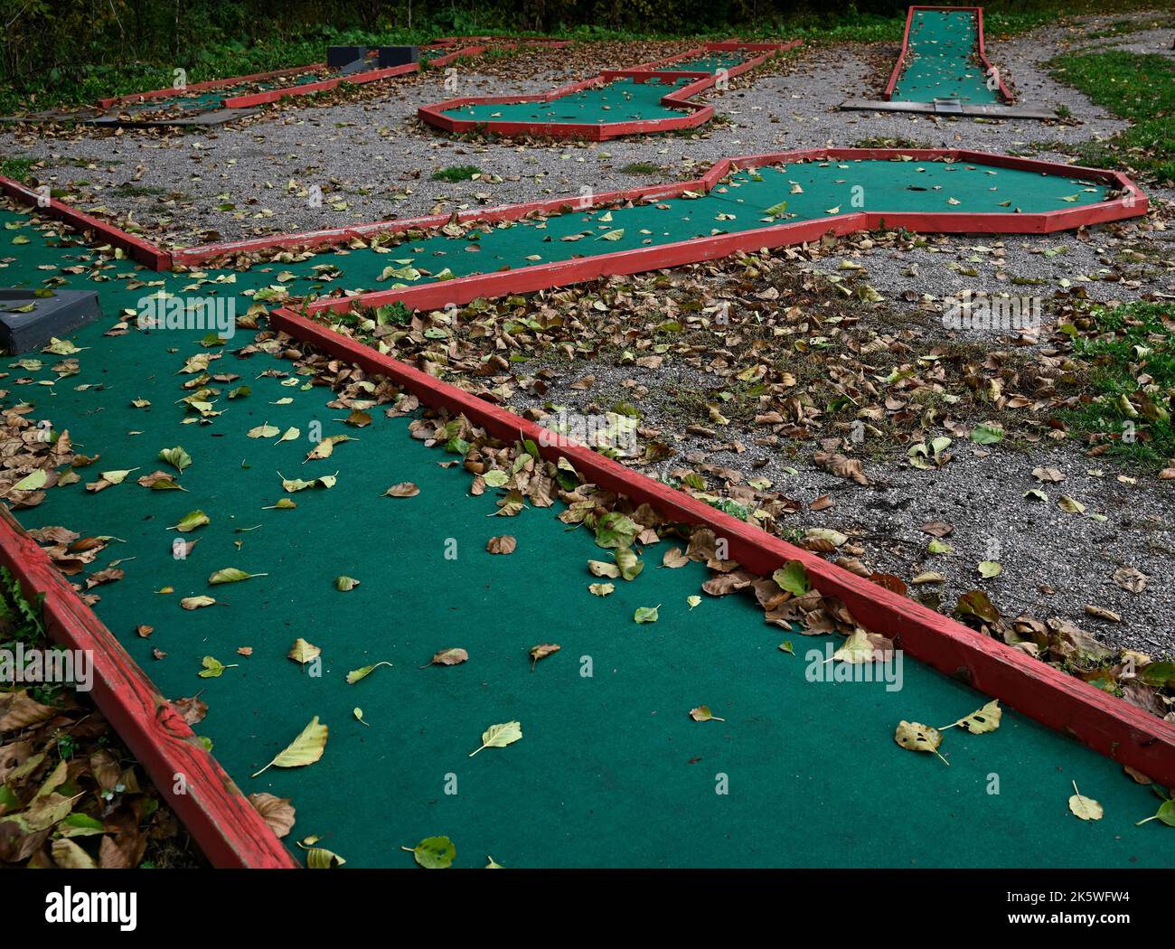 mini golf course in autumn covered with yellow leaves Stock Photo