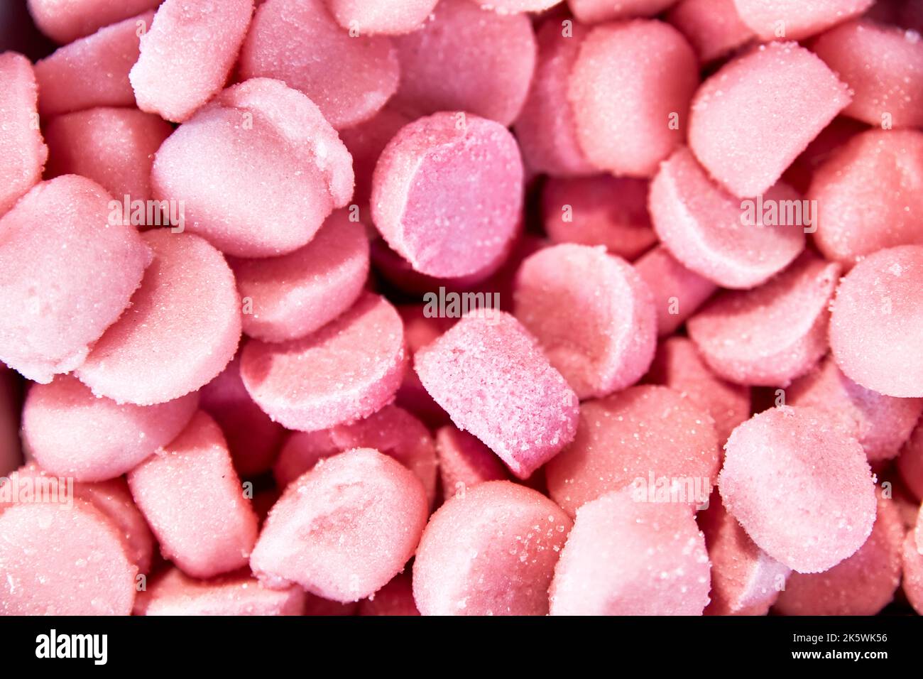 Background of strawberry jelly beans. Unhealthy food. sweets and desserts Stock Photo