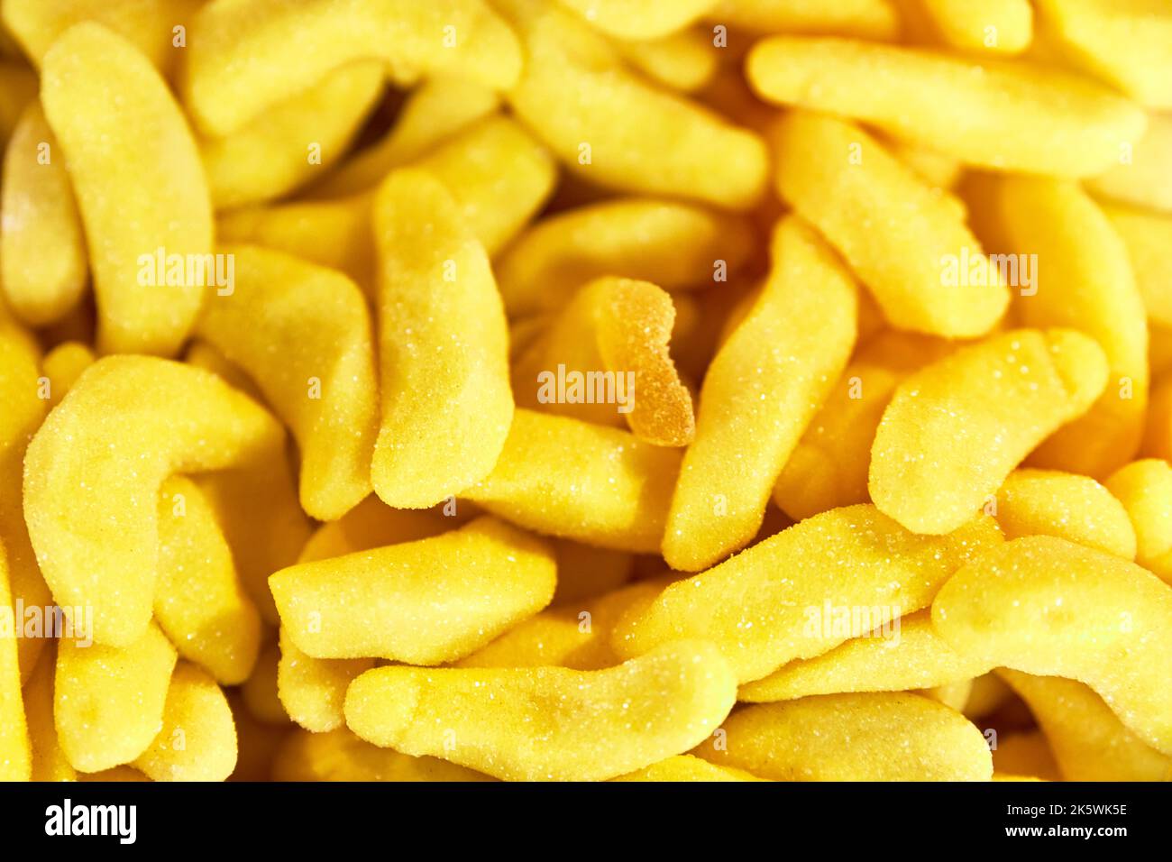Background of banana shaped jelly beans. Unhealthy food. sweets and