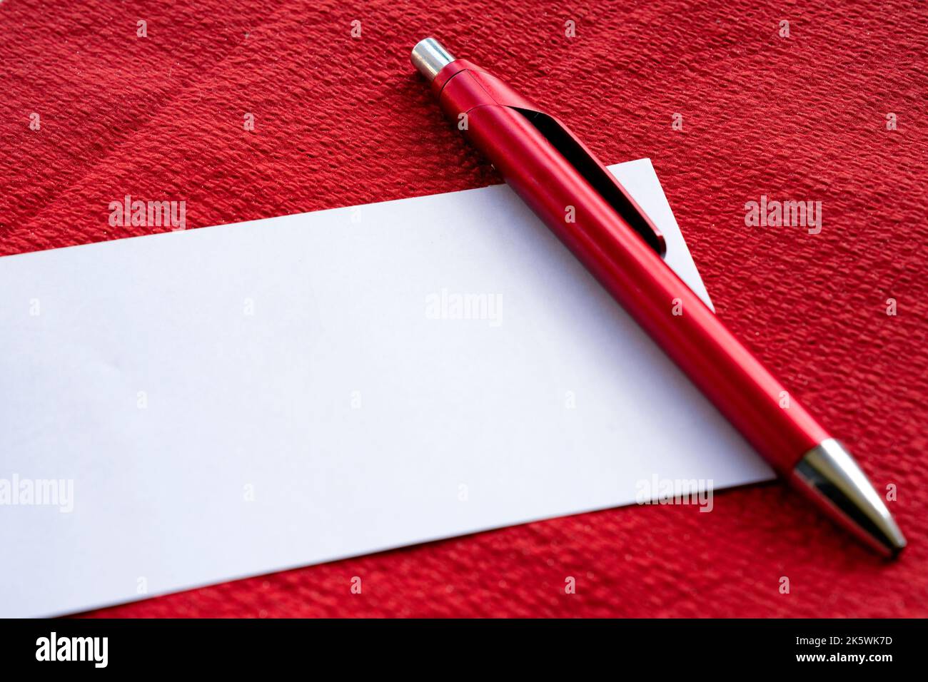 White note paper against RED background with glasses Stock Photo